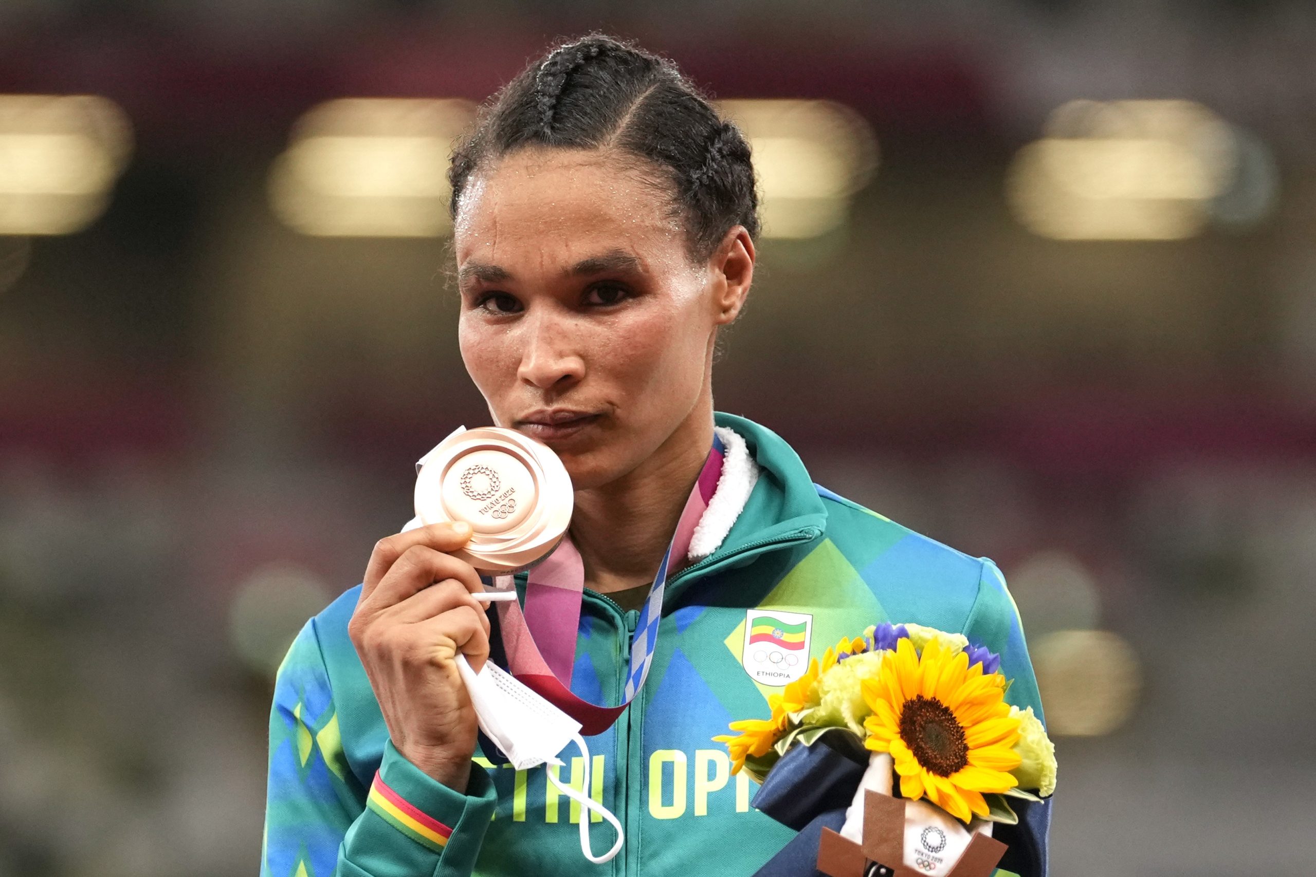 Bronze medalist Letesenbet Gidey, of Ethiopia, reacts during the medal ceremony for the women's 10,000-meters final at the 2020 Summer Olympics, Saturday, Aug. 7, 2021, in Tokyo. (AP Photo/Martin Meissner)