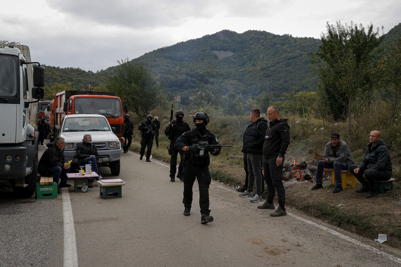 epa09481712 Kosovo Police Special Operations Unit patrol the area near the border crossing between Kosovo and Serbia in Jarinje, Kosovo, 22 September 2021. Kosovo Serbs in the northern part of the ethnically divided town of Mitrovica set up road barricades with trucks and cars to protest against the Kosovo government’s entry ban on vehicles with Serbian registration plates.  EPA/VALDRIN XHEMAJ