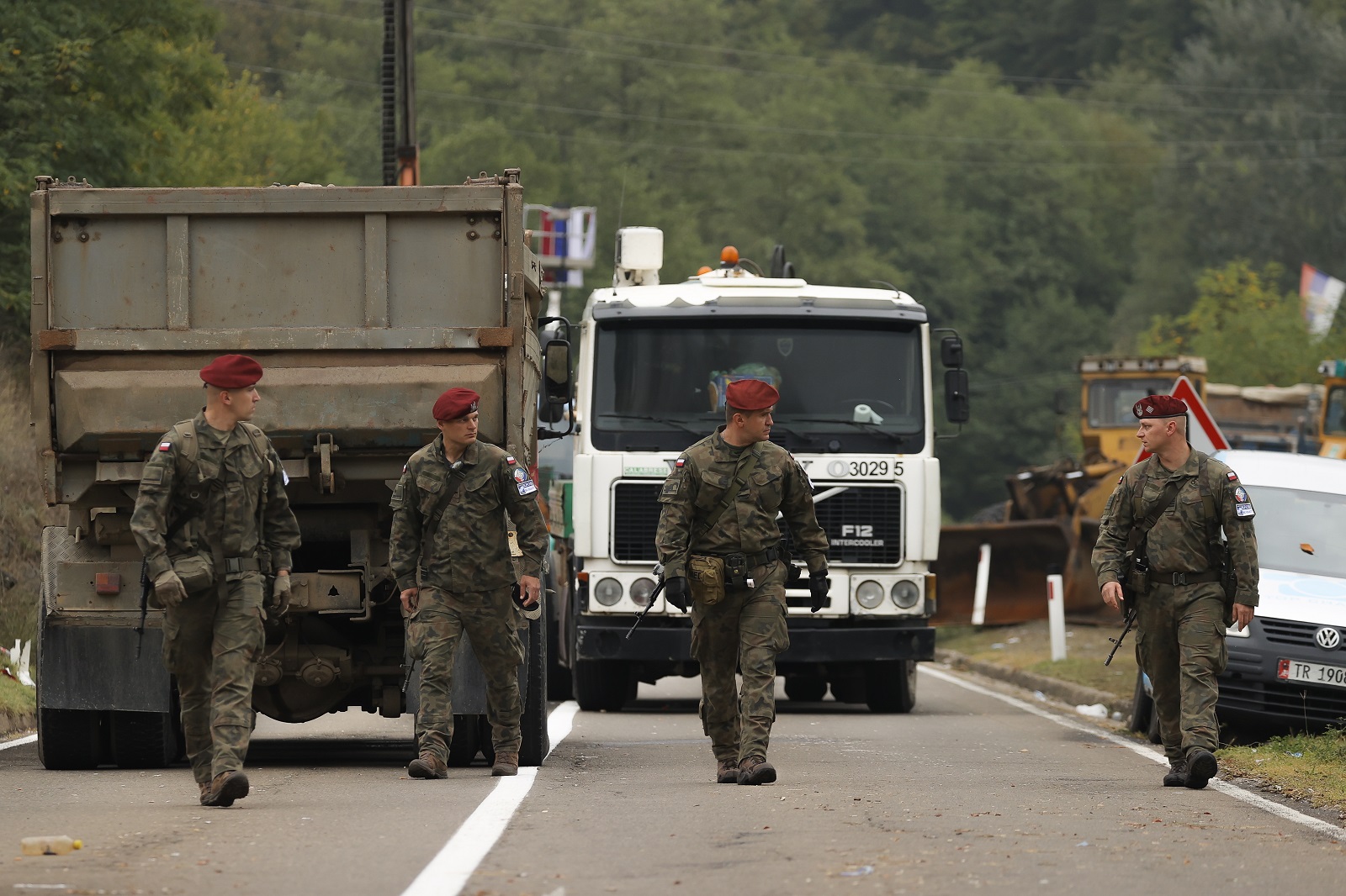 epa09492596 NATO peacekeepers patrol the area near the border crossing between Kosovo and Serbia in Jarinje, Kosovo, 28 September 2021. Kosovo Serbs in the northern part of the ethnically divided town of Mitrovica set up road barricades with trucks and cars to protest against the Kosovo government’s entry ban on vehicles with Serbian registration plates.  EPA/VALDRIN XHEMAJ