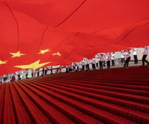 epaselect epa09499004 People display a huge Chinese flag during a ceremony celebrating China's National Day at the waterfront of the Victoria Harbour in Hong Kong, China, 01 October 2021. China celebrates its National Day on 01 October 2021, marking the 72nd founding anniversary of the People's Republic of China.  EPA/JEROME FAVRE