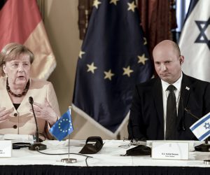 epa09516171 German Chancellor Angela Merkel (L) attends a cabinet meeting with Israeli Prime Minister Naftali Bennett (R) in Jerusalem, 10 October 2021. Germany's outgoing Chancellor Angela Merkel said Israel's security will be a top priority for 'every German government' during a farewell tour in the Jewish state on the day, as she prepares to end a 16-year term in office.  EPA/MENAHEM KAHANA / POOL