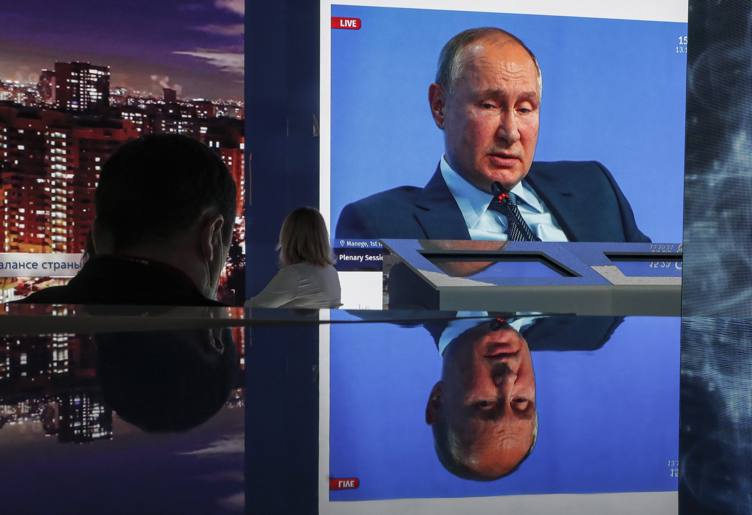 epaselect epa09521836 A screen shows Russian President Vladimir Putin attends a plenary session during the REW 2021 Russian Energy Week international forum at the Manege Central Exhibition Hall in Moscow, Russia, 13 October 2021. The forum takes place from 13 to 14 October.  EPA/SERGEI ILNITSKY