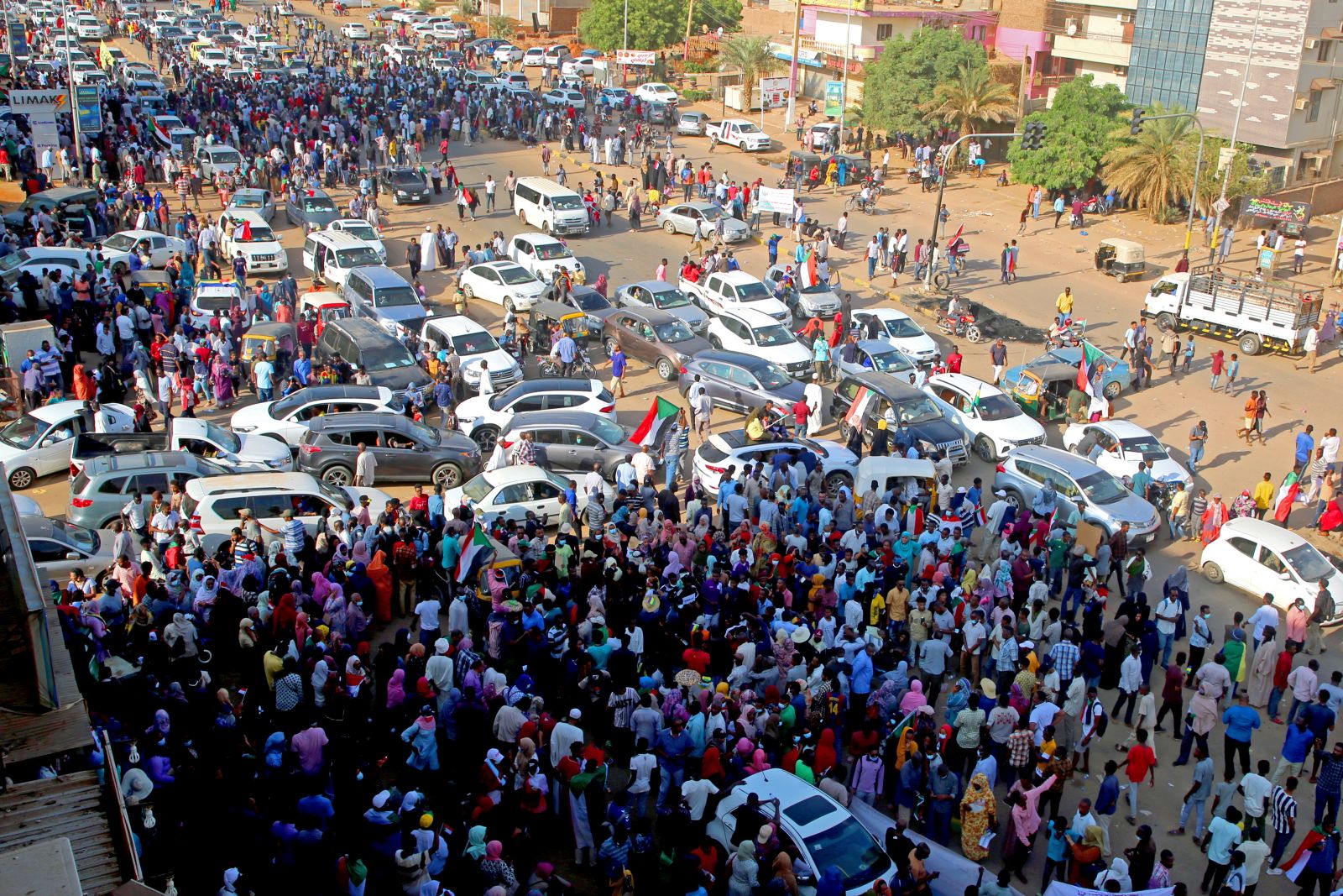 epa09537118 People attend demonstrations in support of the civilian government, in Khartoum, Sudan, 21 October 2021. Thousands of people marched during a demonstration called by the Alliance of Forces for Freedom and Change, the Central Council Group to support the government of Abdullah Hamdok, while the army and police forces closed the roads leading to government headquarters and main markets.  EPA/MOHAMMED ABU OBAID