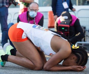 epa09542717 Ethiopian athlete Letesenbet Gidey reacts after crossing the finish line and breaking the world record at Valencia Half Marathon in the coastal city of Valencia, eastern Spain, 24 October 2021. Gidey has set an official time of 1:02:52, lowering by 1 minute and 10 seconds the previous world record set by Kenyan Ruth Chepngetich last April.  EPA/Miguel Angel Polo