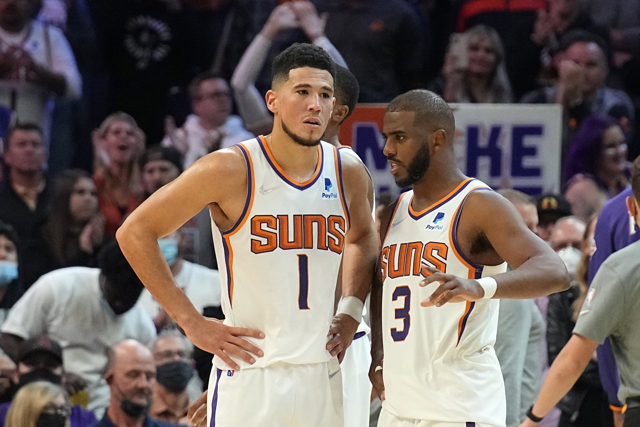 Phoenix Suns guard Devin Booker (1) and guard Chris Paul (3) during the second half of an NBA basketball game against the Sacramento Kings, Wednesday, Oct. 27, 2021, in Phoenix. (AP Photo/Rick Scuteri)