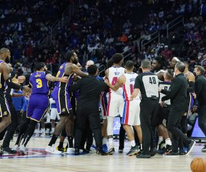 Players separate Los Angeles Lakers forward LeBron James, left, and Detroit Pistons center Isaiah Stewart, far right center, during the second half of an NBA basketball game, Sunday, Nov. 21, 2021, in Detroit. (AP Photo/Carlos Osorio)