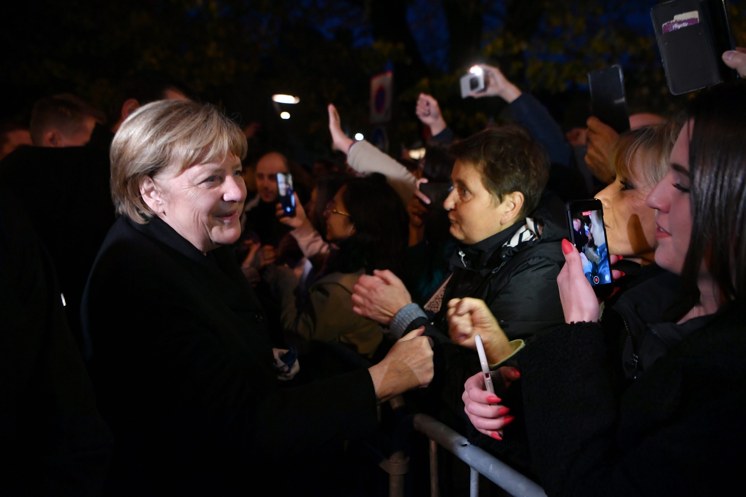 epa09561674 Outgoing German Chancellor Angela Merkel (L) is greeted by members of the public prior to talks with France's President Emmanuel Macron, in Beaune, Eastern France, on 03 November 2021.  EPA/PHILIPPE DESMAZES / POOL  MAXPPP OUT