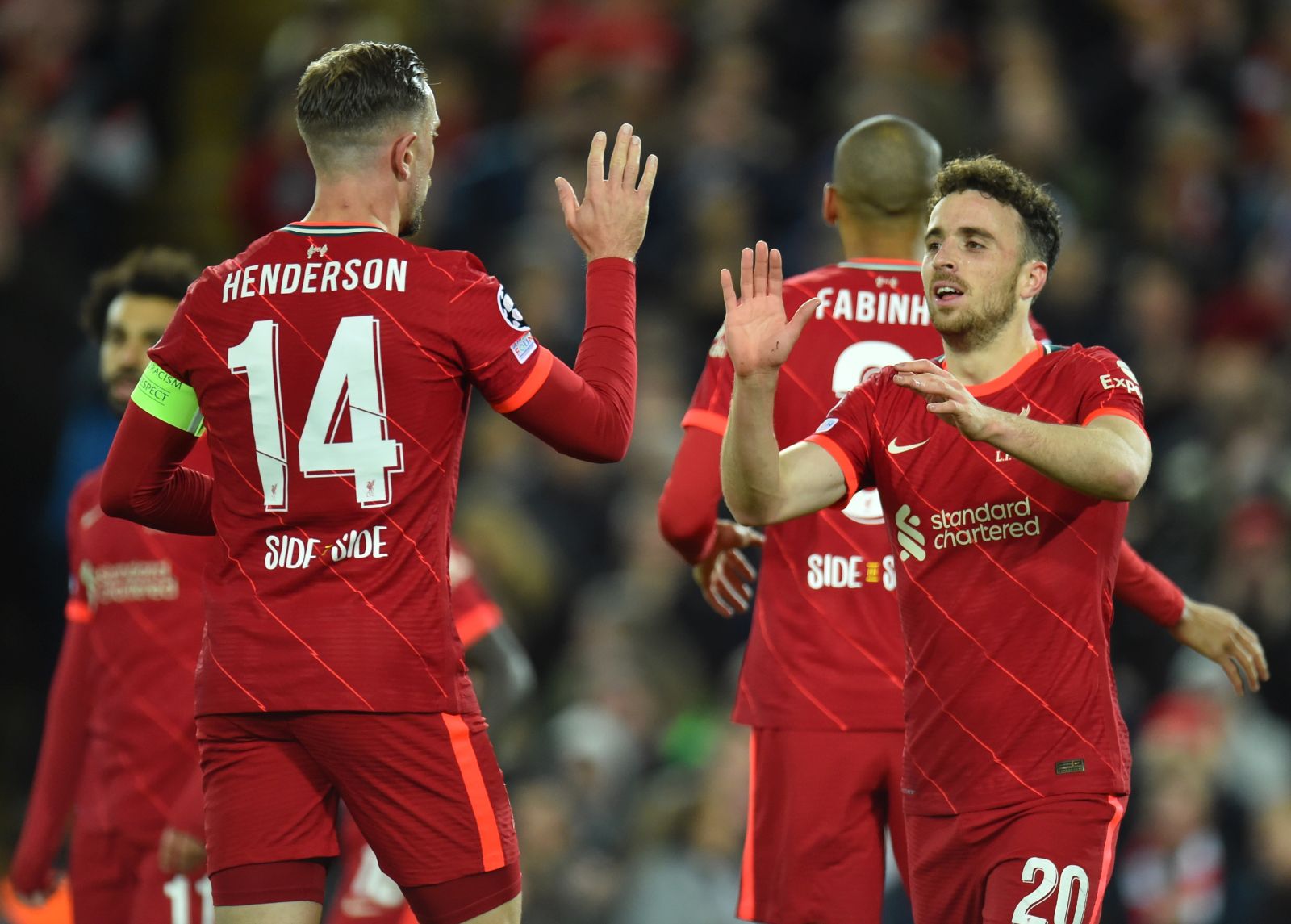 epa09562092 Liverpool's Diogo Jota (R) celebrates with teammate Jordan Henderson (L) after scoring the 1-0 lead during the UEFA Champions League group B soccer match between Liverpool FC and Atletico Madrid in Liverpool, Britain, 03 November 2021.  EPA/Peter Powell