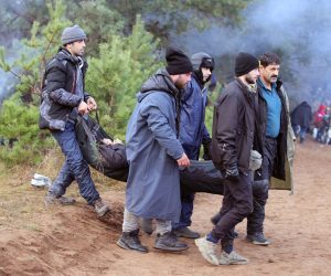 epa09572064 A handout photo made available by Belta news agency shows migrants carrying an injured person on the Belarusian-Polish border in the Grodno region, Belarus, 08 November 2021 (issued 09 November 2021). According to the State Border Committee of Belarus, there are more than two thousand people near the border, including women and children, who want to obtain asylum in the European Union, 'and they do not consider the territory of the Republic of Belarus as a place of stay.' Against this background, the Polish authorities announced preparations for a breakthrough across the border. The territory is guarded by several thousand employees of the Polish special services. The migration crisis at the border of Belarus has been going on since the spring of 2021. Belarus President Alexander Lukashenko said that after the introduction of new EU sanctions against Minsk, the Belarusian authorities will no longer interfere with the movement of illegal migrants to the European Union.  EPA/LEONID SCHEGLOV / HANDOUT  HANDOUT EDITORIAL USE ONLY/NO SALES