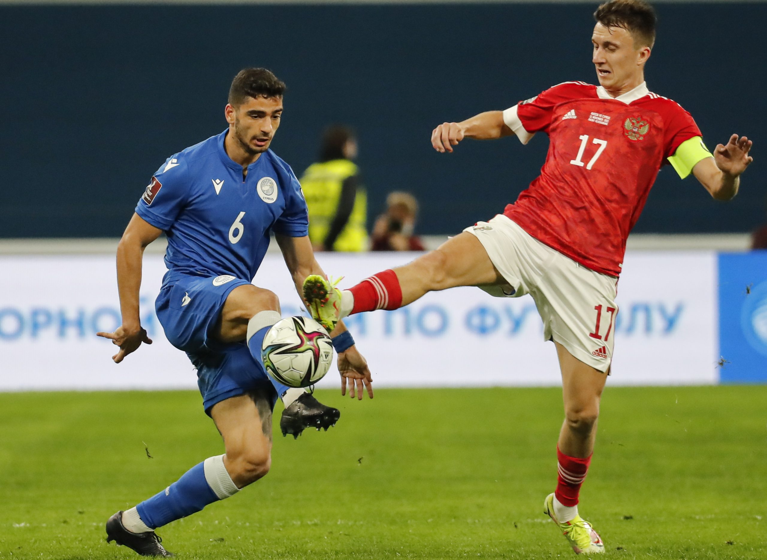 epa09576689 Aleksandr Golovin (R) of Russia in action against Paris Psaltis (L) of Cyprus during the FIFA World Cup 2022 group H qualifying soccer match between Russia and Cyprus in St.Petersburg, Russia, 11 November 2021.  EPA/Anatoly Maltsev