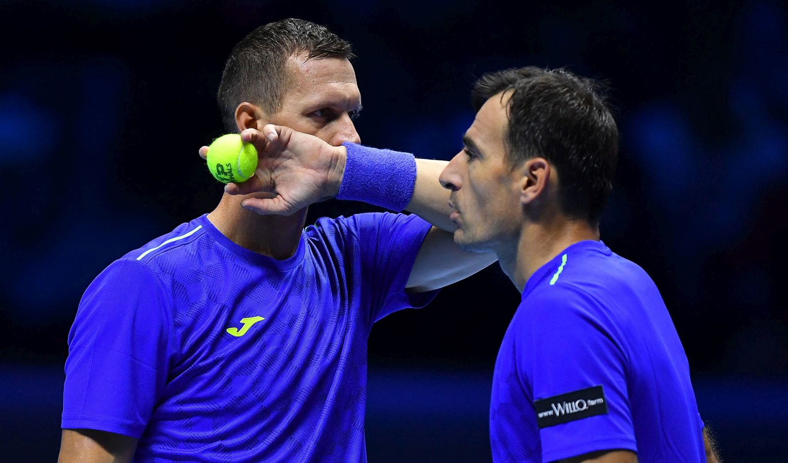 epa09582347 Ivan Dodig of Croatia and Filip Polasek of Slovakia (L) react during the doubles match against Horacio Zeballos of Argentina (R) and Marcel Granollers of Spain at the Nitto ATP Finals in Turin, Italy, 14 November 2021.  EPA/ALESSANDRO DI MARCO