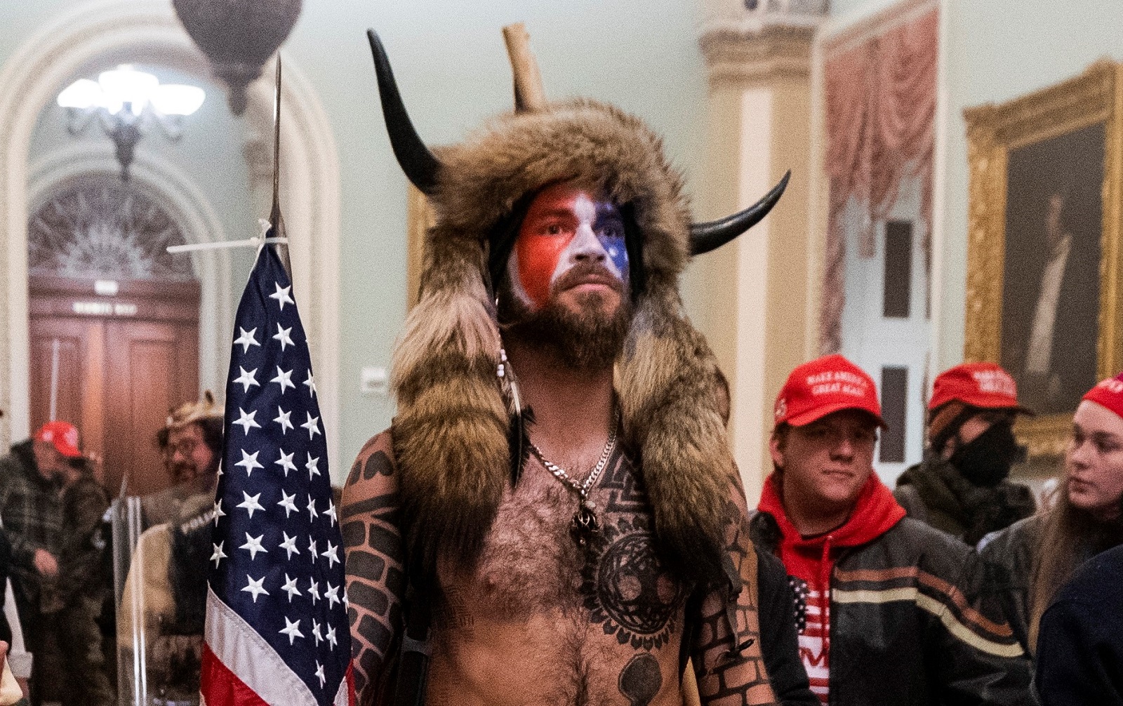 epa09587580 (FILE) - Supporters of US President Donald J. Trump, including 'QAnon Shaman' Jacob Anthony Angeli Chansley (C), stand by the door to the Senate chambers after they breached the US Capitol security in Washington, DC, USA, 06 January 2021 (reissued 17 November 2021). Chansley was sentenced to 41 months in prison on 17 November 2021 for his role in the 06 January 2021 breach of the Capitol.  EPA/JIM LO SCALZO