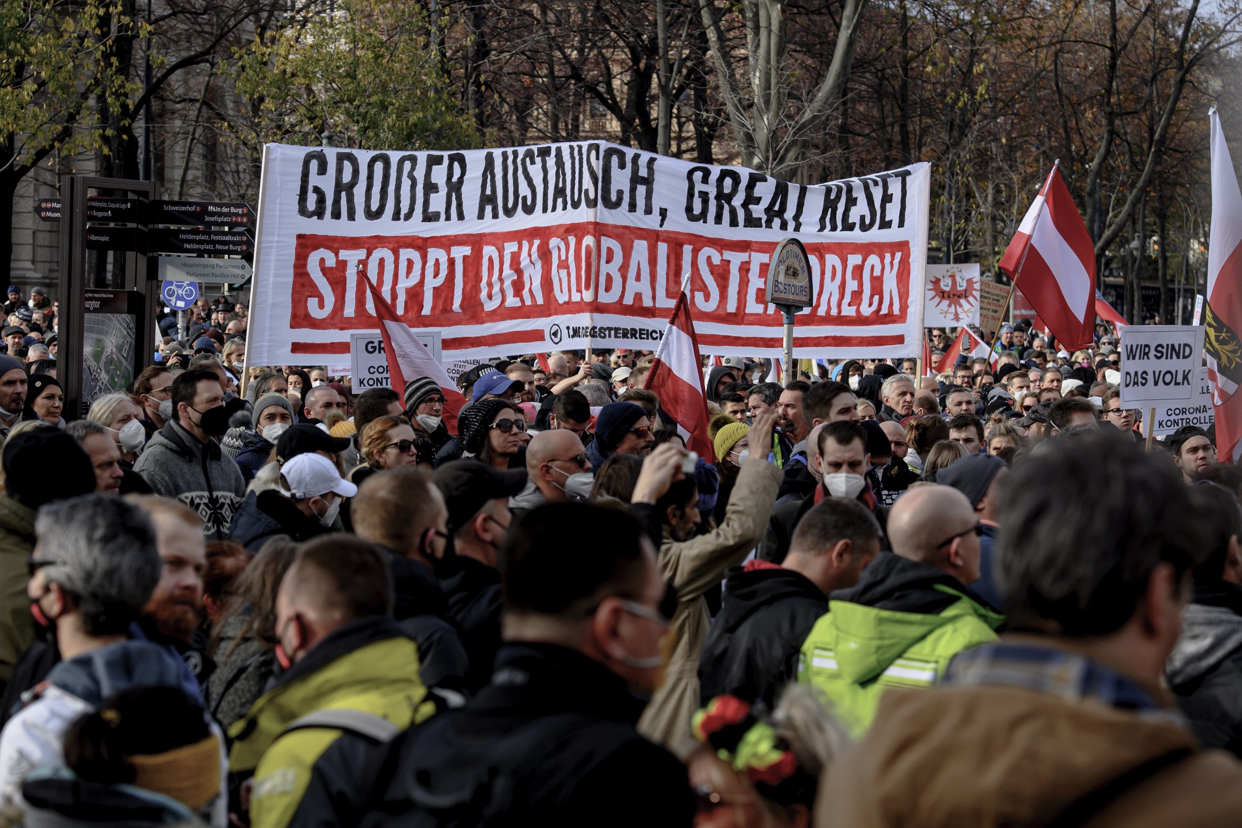 epa09593377 Protesters display a banner reading 'Grosser Austausch, great Reset Stoppt den Globalistendreck' ('Great exchange, Great Reset, Stop the globalist filth') during a demonstration against the measures of the Austrian government to slow down the ongoing pandemic of the COVID-19 disease caused by the SARS-CoV-2 coronavirus in Vienna, Austria, 20 November 2021. Austrian Chancellor Alexander Schallenberg announced a mandatory vaccination against the SARS-CoV-2 coronavirus by February 2022, and a general nationwide lockdown to stem the ongoing pandemic of COVID-19, starting from 22 November.  EPA/CHRISTIAN BRUNA