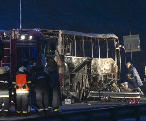 epa09598488 Fire fighters, police officers and investigators inspect the wreckage of a bus with North Macedonian plates that caught fire on a highway, killing at least 45 people, near the village of Bosnek, Bulgaria, 23 November 2021.  EPA/VASSIL DONEV