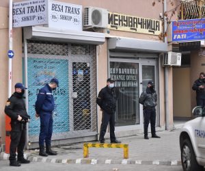 epa09598649 Police officers stand guard in front of the offices of 'Besa Trans' travel agency in Skopje, Republic of North Macedonia, 23 November 2021. At least 45 people died after a bus owned by the agency caught fire near the village of Bosnek, Bulgaria.  EPA/GEORGI LICOVSKI