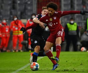 epa09607735 Munich's Leroy Sane (R) in action against Bielefeld's Patrick Wimmer (L) during the German Bundesliga soccer match between Bayern Muenchen and Arminia Bielefeld in Munich, Germany, 27 November 2021.  EPA/PHILIPP GUELLAND CONDITIONS - ATTENTION: The DFL regulations prohibit any use of photographs as image sequences and/or quasi-video.