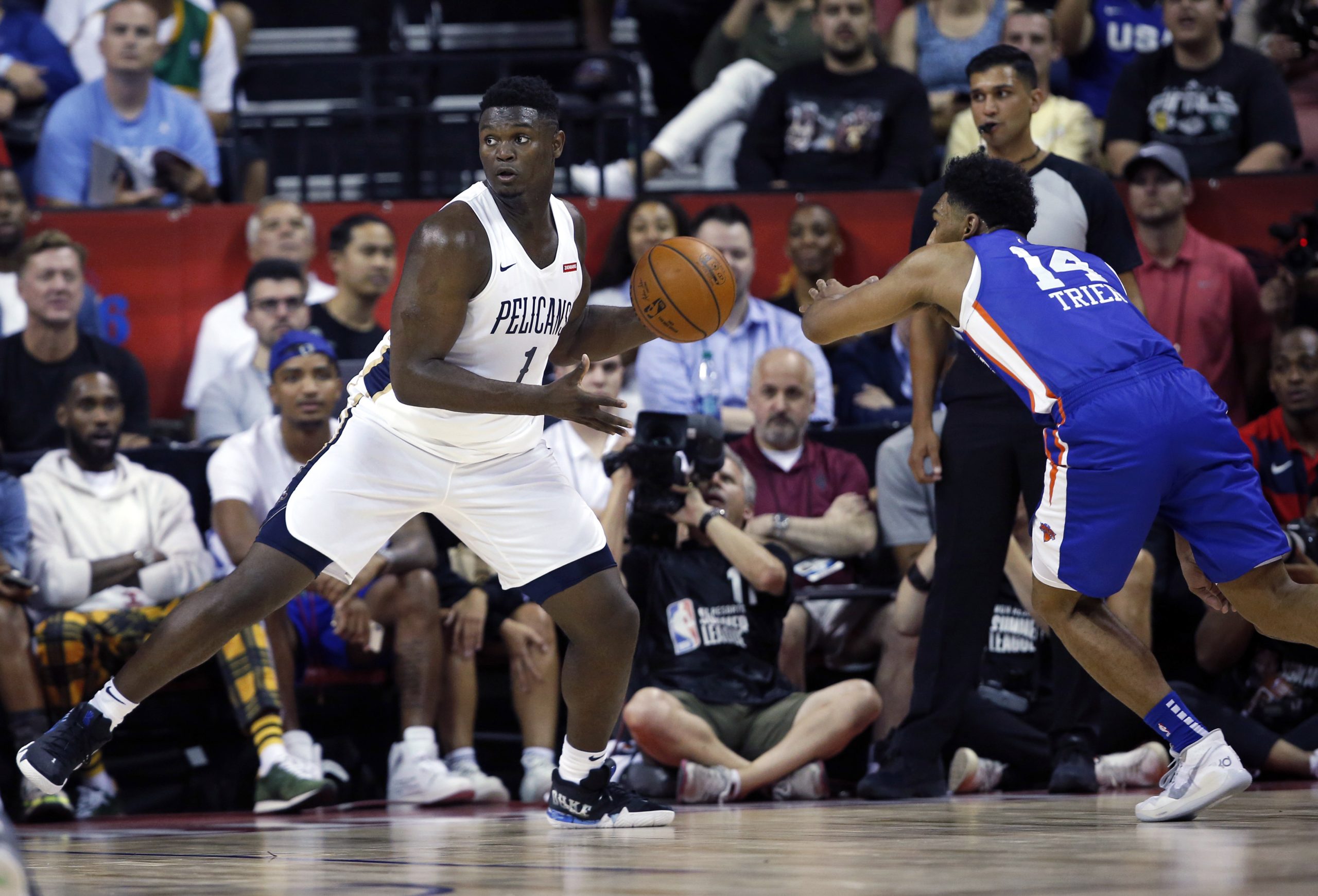 New Orleans Pelicans' Zion Williamson (1) looks to pass the ball during the team's NBA summer league basketball game against the New York Knicks on Friday, July 5, 2019, in Las Vegas. Knicks' Allonzo Trier is at right. (AP Photo/Steve Marcus)