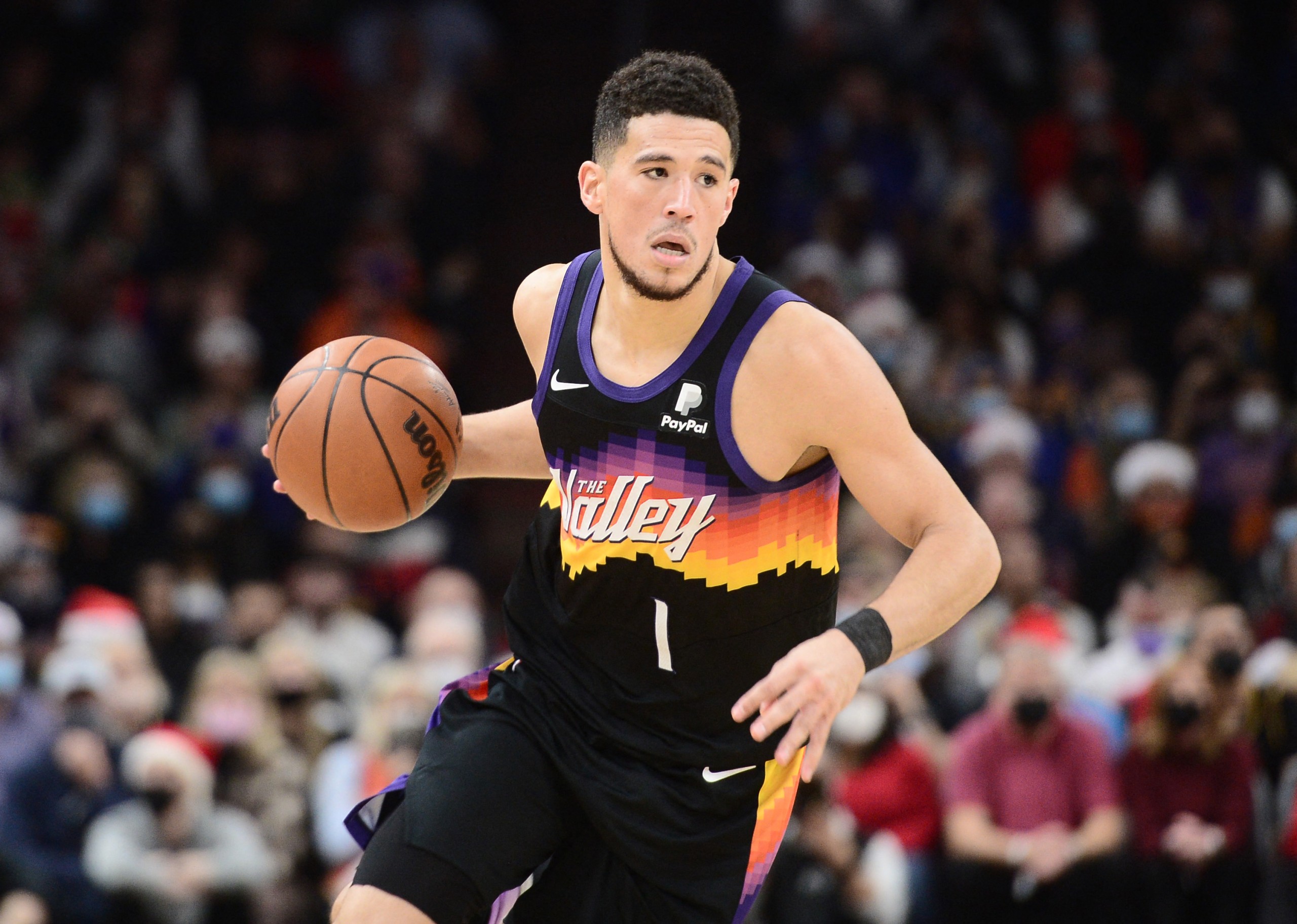 Dec 25, 2021; Phoenix, Arizona, USA; Phoenix Suns guard Devin Booker (1) dribbles against the Golden State Warriors during the first half at Footprint Center. Mandatory Credit: Joe Camporeale-USA TODAY Sports