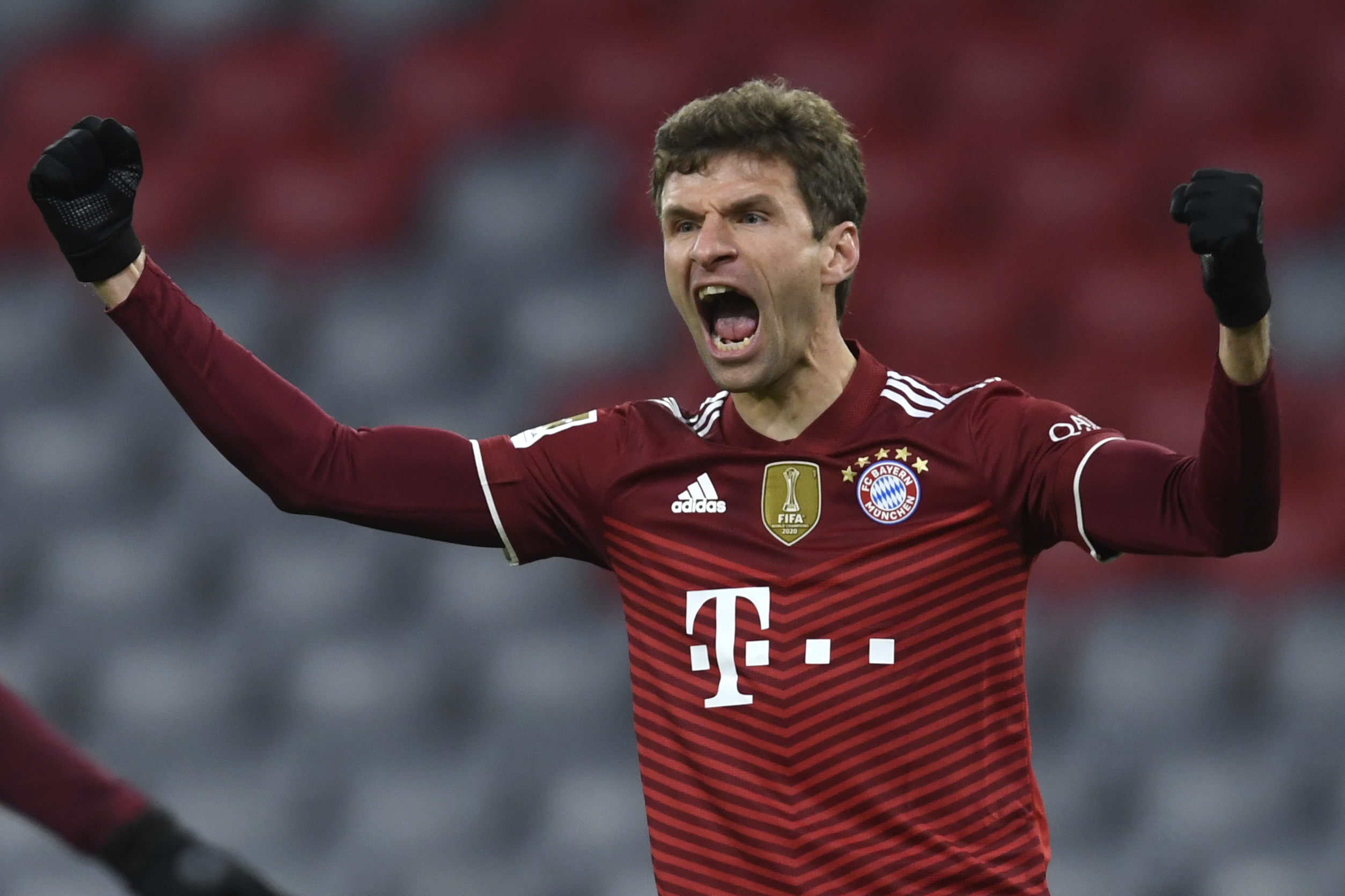 Bayern's Thomas Mueller celebrates after scoring his sides first goal during a German Bundesliga soccer match between Bayern Munich and VfL Wolfsburg at the Allianz Arena in Munich, Germany, Friday, Dec. 17, 2021. (AP Photo/Andreas Schaad)