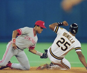 Cincinnati Reds' Barry Larkin, left, tags out Pirates right fielder Bobby Bonilla attempting to steal second base in the first inning of the National League Championship Series in Pittsburgh, Tuesday, Oct. 9, 1990. (AP Photo/Gene Puskar)