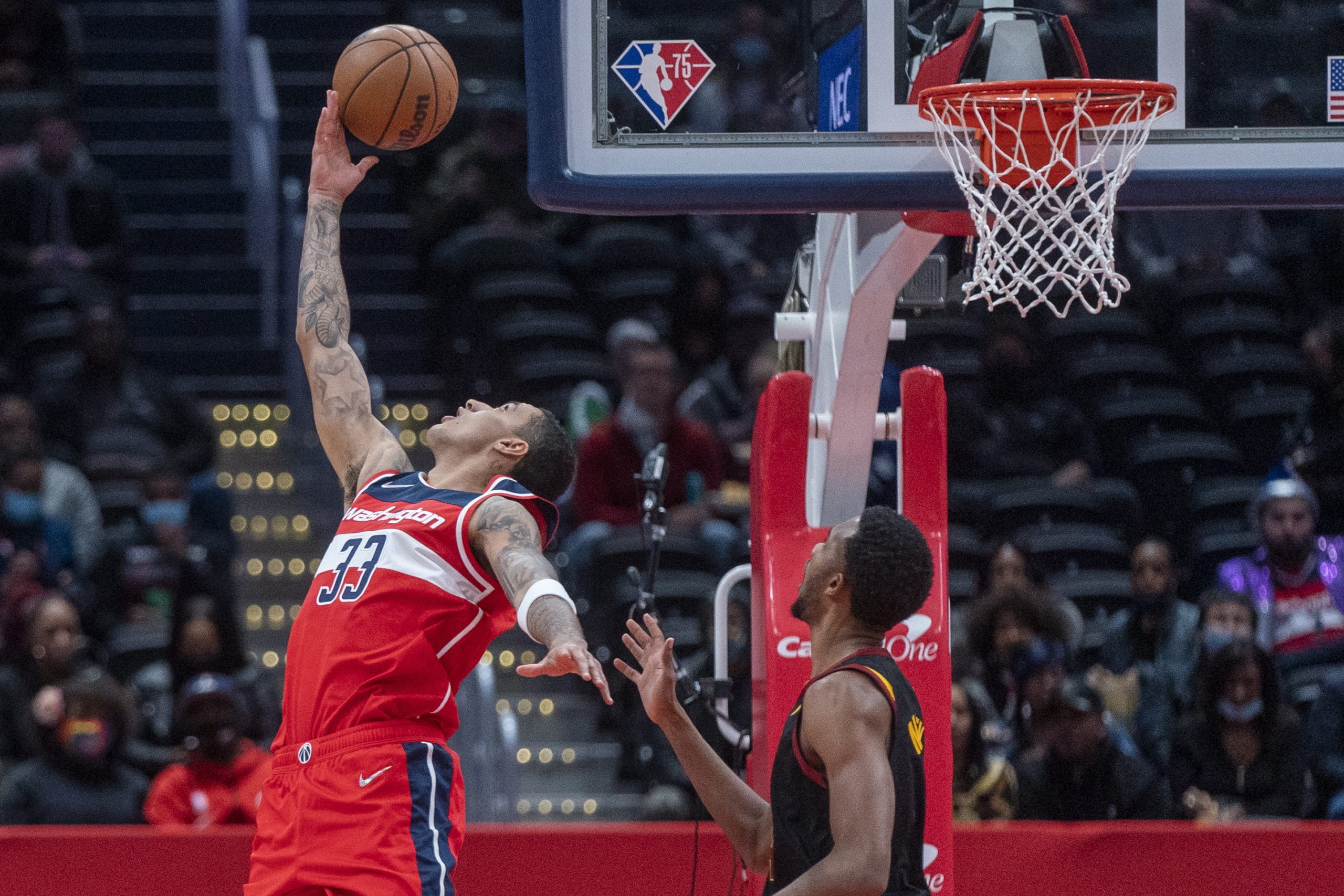 epa09620003 Washington Wizards forward Kyle Kuzma (L) in action against the Cleveland Cavaliers defense during the NBA basketball game between the Cleveland Cavaliers and the Washington Wizards at Capital One Arena in Washington, DC, USA, 03 December 2021.  EPA/SHAWN THEW SHUTTERSTOCK OUT
