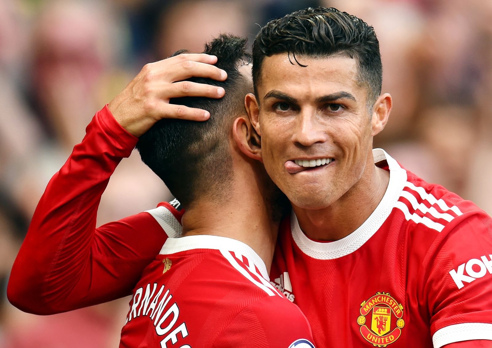epa09620895 Bruno Fernandes of Manchester United (L) is being congratulated by teammate Cristiano Ronaldo after scoring his team's third goal during the English Premier League soccer match between Manchester United and Newcastle United in Manchester, Britain, 11 September 2021.  EPA/PETER POWELL EDITORIAL USE ONLY *** Local Caption *** 57166936