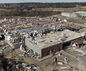 epa09638905 An aerial photo made with a drone shows the destruction of the Mayfield Consumer Products candle factory after tornadoes moved through the area leaving destruction and death across six states, in Mayfield, Kentucky, USA, 12 December 2021. According to reports more than 70 people lost their lives in Kentucky with more dead in Arkansas in the storms on 10 December.  EPA/TANNEN MAURY