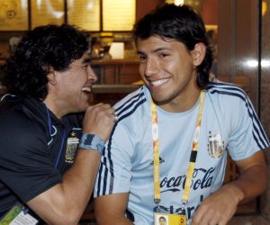 epa09642898 (FILE) - Former Argentinean soccer player Diego Armando Maradona (L) and Sergio Aguero (R) share a light moment during the 2008 Beijing Olympic Games in Beijing, China, 19 August 2008 (re-issued on 15 December 2021). Argentinian striker Sergio 'Kun' Aguero announced his retirement during a press conference in Barcelona, Spain, on 15 December 2021.  EPA/Jesus Diges