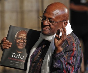 epa09656971 (FILE) - Former South African Anglican Archbishop Desmond Tutu poses with a copy of the book 'Tutu: The Authorised Portrait', during the book launch at the St Georges Cathedral in Cape Town, South Africa, 06 October 2011 (reissued 26 December 2021). Desmond Tutu has died aged 90, the South African presidency said on 26 December 2021. As a leading spokesperson for the rights of black South Africans, Tutu in 1984 received the Nobel Prize for Peace for his role in the opposition to apartheid in South Africa.  EPA/NIC BOTHMA