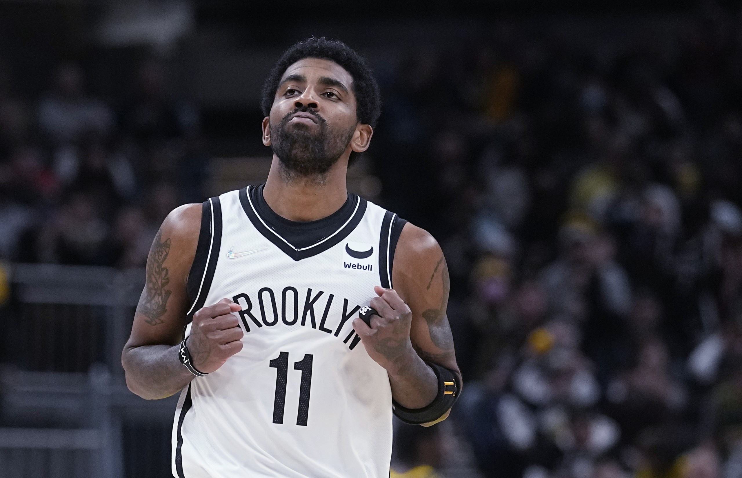 Brooklyn Nets' Kyrie Irving reacts after hitting a shot during the second half of the team's NBA basketball game against the Indiana Pacers, Wednesday, Jan. 5, 2022, in Indianapolis. (AP Photo/Darron Cummings)