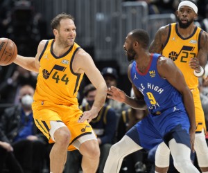 Utah Jazz forward Bojan Bogdanovic, left, looks to pass the ball as Denver Nuggets guard Davon Reed defends in the first half of an NBA basketball game Wednesday, Jan. 5, 2022, in Denver. (AP Photo/David Zalubowski)