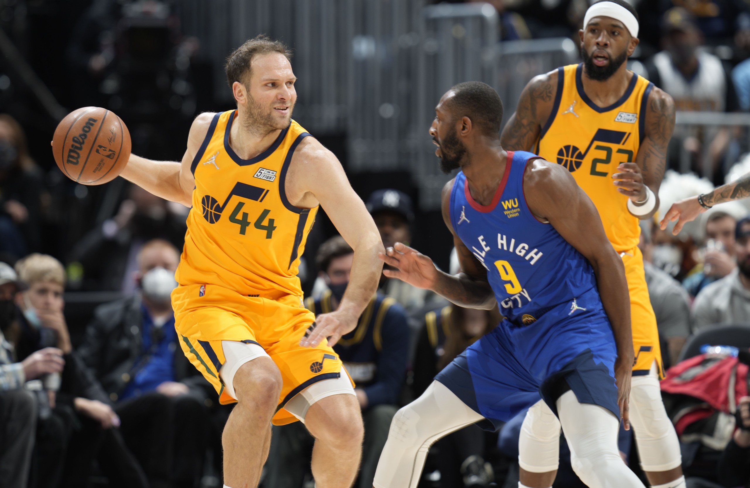 Utah Jazz forward Bojan Bogdanovic, left, looks to pass the ball as Denver Nuggets guard Davon Reed defends in the first half of an NBA basketball game Wednesday, Jan. 5, 2022, in Denver. (AP Photo/David Zalubowski)