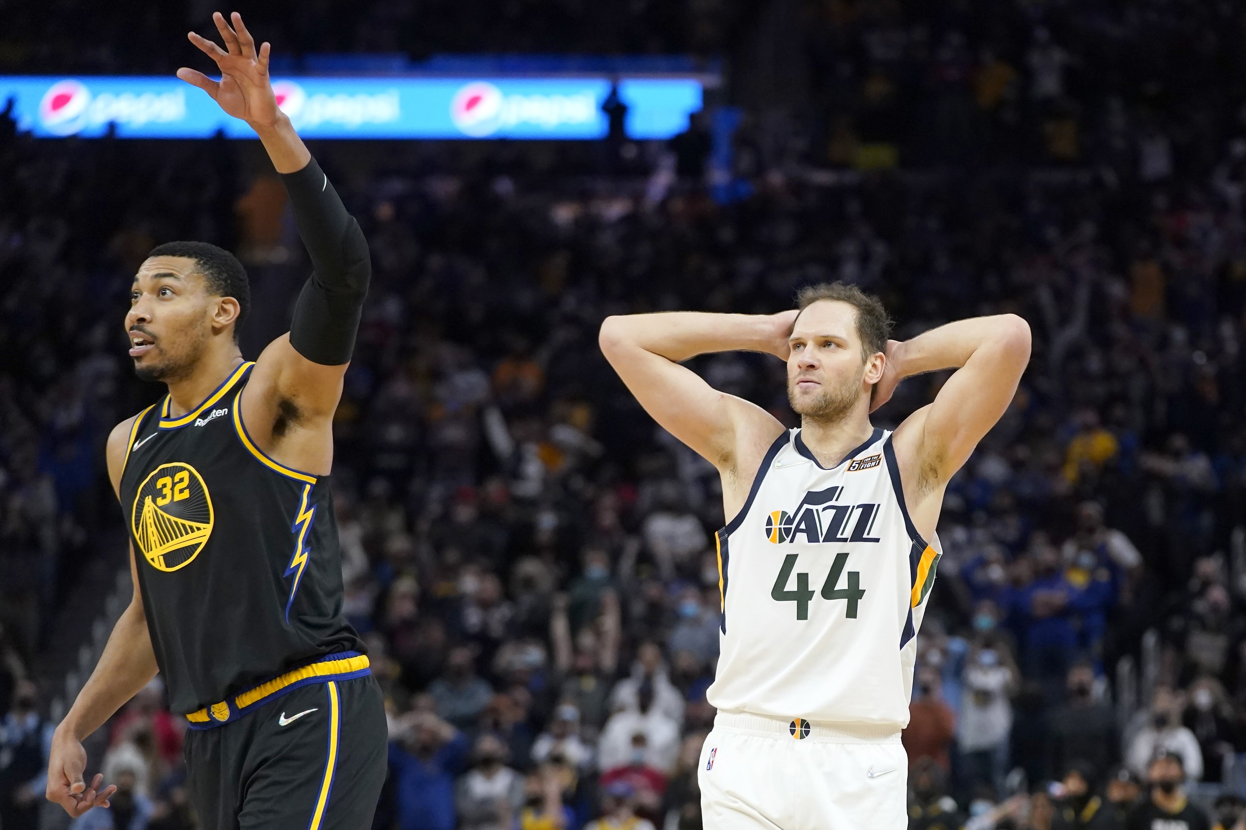Utah Jazz forward Bojan Bogdanovic (44) reacts as he watches a missed shot next to Golden State Warriors forward Otto Porter Jr. (32) during the second half of an NBA basketball game in San Francisco, Sunday, Jan. 23, 2022. (AP Photo/Jeff Chiu)