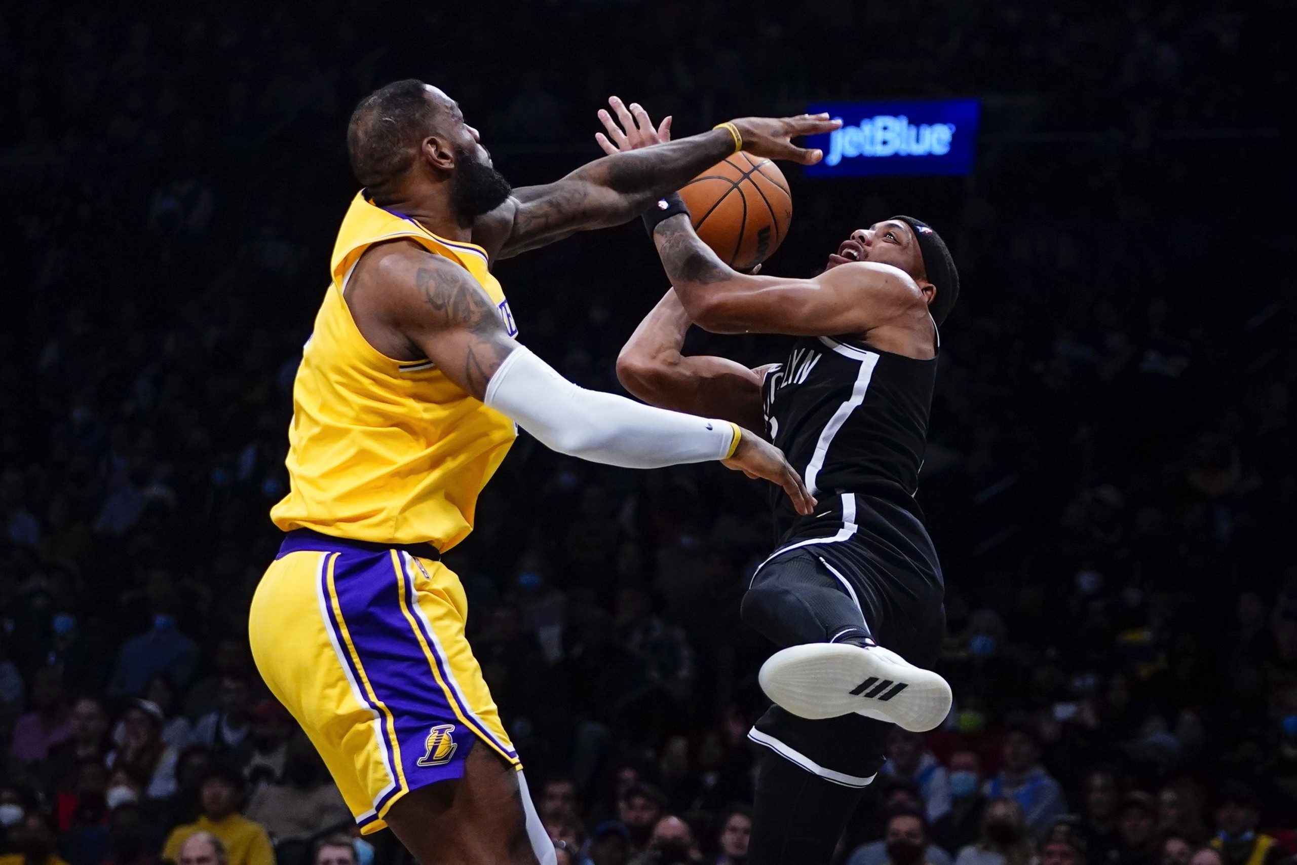 Los Angeles Lakers' LeBron James, left, blocks a shot by Brooklyn Nets' Bruce Brown, right, during the second half of an NBA basketball game Tuesday, Jan. 25, 2022 in New York. The Lakers won 106-96. (AP Photo/Frank Franklin II)