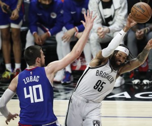 epa09658362 Brooklyn Nets guard DeAndre' Bembry (R) passes the ball to a teammate while being guarded by LA Clippers center Ivica Zubac (L) during the third quarter of the NBA basketball game between the Los Angeles Lakers and Brooklyn Nets at Crypto.com Arena in Los Angeles, California, USA, 27 December 2021.  EPA/CAROLINE BREHMAN  SHUTTERSTOCK OUT