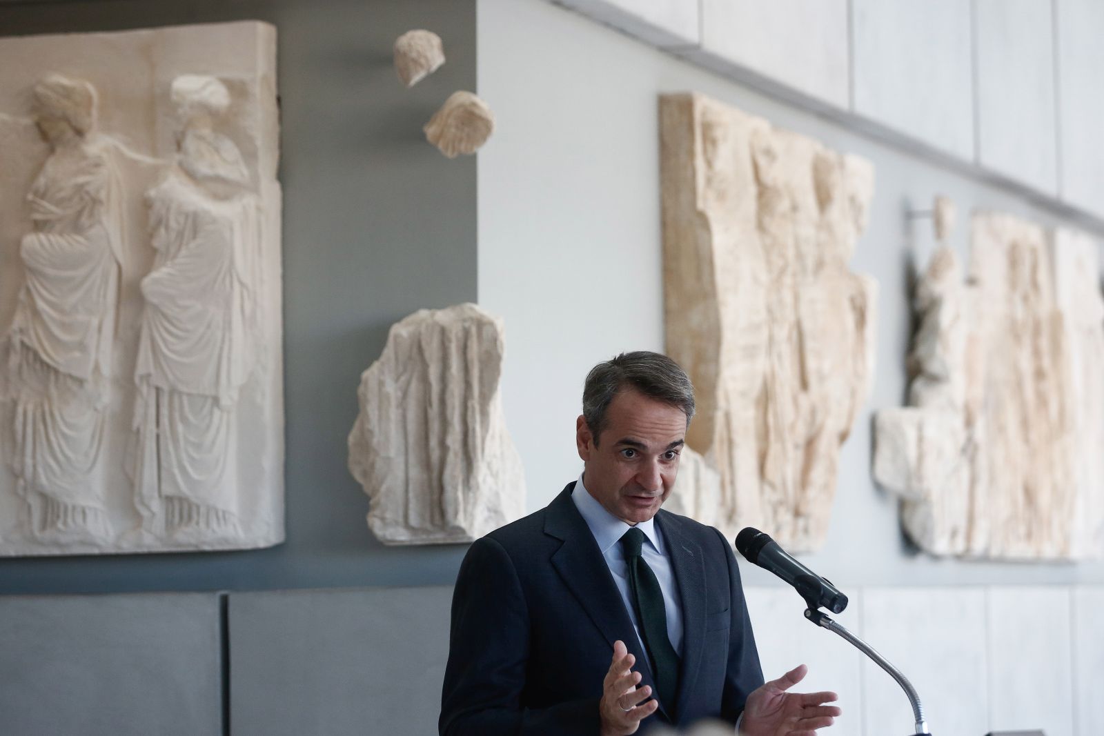 epa09664679 Greek Prime Minister Kyriakos Mitsotakis delivers a speech during a ceremony marking the arrival of fragments of the sculptural decoration of the Parthenon at the Acropolis Museum in Athens, Greece, 03 January 2022. Ten fragments of the Parthenon were transferred from the warehouse of the National Archaeological Museum, where they were kept, for display at the Acropolis Museum.  EPA/YANNIS KOLESIDIS