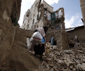 epa09666718 A Yemeni woman salvages belongings from her old building after it was partially collapsed in the UNESCO-listed city of Sana'a, Yemen, 04 January 2022. The old building was evacuated hours before it partially collapsed from cracks. UNESCO added the historic city of Sana'a to the list of world heritage sites in danger in July 2015 due to damage caused by the floods and the potential threat from the armed conflict in the Arab country. The old city of Sana'a was inscribed by UNESCO on the World Heritage List in 1986 as it is one of the oldest continuously-inhabited cities in the world. It has a unique architectural legacy of nearly 6,000 distinctive multi-story tower houses and 103 mosques.  EPA/YAHYA ARHAB