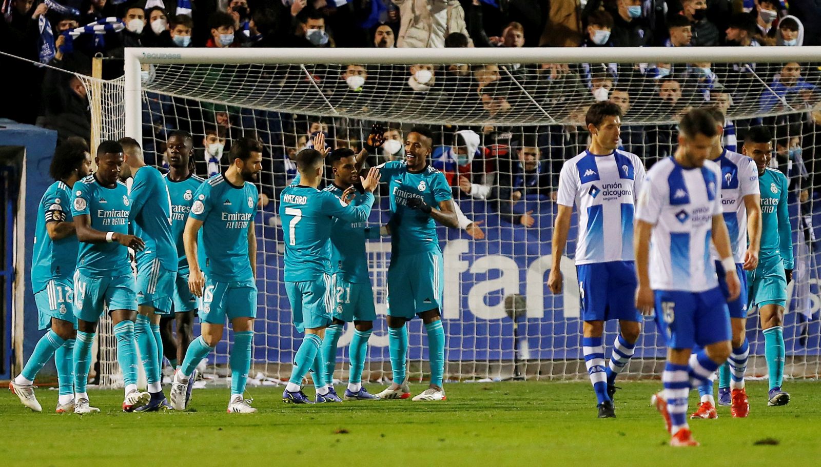 epa09668583 Real Madrid's Brazilian defender Eder Militao (C) celebrates with teammates after scoring the 0-1 goal during the Spanish King's Cup round of 32 match between CD Alcoyano and Real Madrid at Estadio El Collao, in Alcoy, eastern Spain, 05 January 2022.  EPA/Manuel Lorenzo