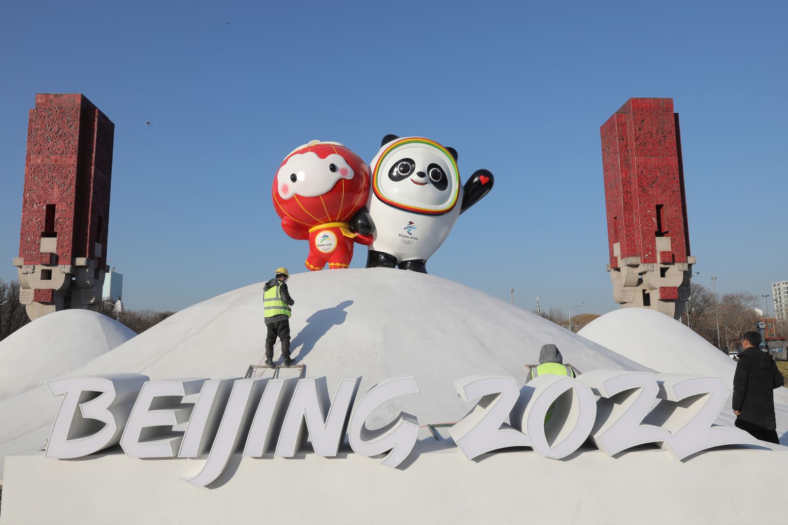 epa09678214 Chinese workers spray paint near the Bing Dwen Dwen, the Beijing 2022 Winter Olympic Mascot and Shuey Rhon Rhon, the 2022 Beijing Winter Paralympic Games Mascot, in Beijing, China, 11 January 2022. China is scheduled to host the Beijing 2022 Olympic and Paralympic Winter Games in February, making its capital the first city in the world to host both Summer (2008) and Winter Olympics (2022).  EPA/WU HONG