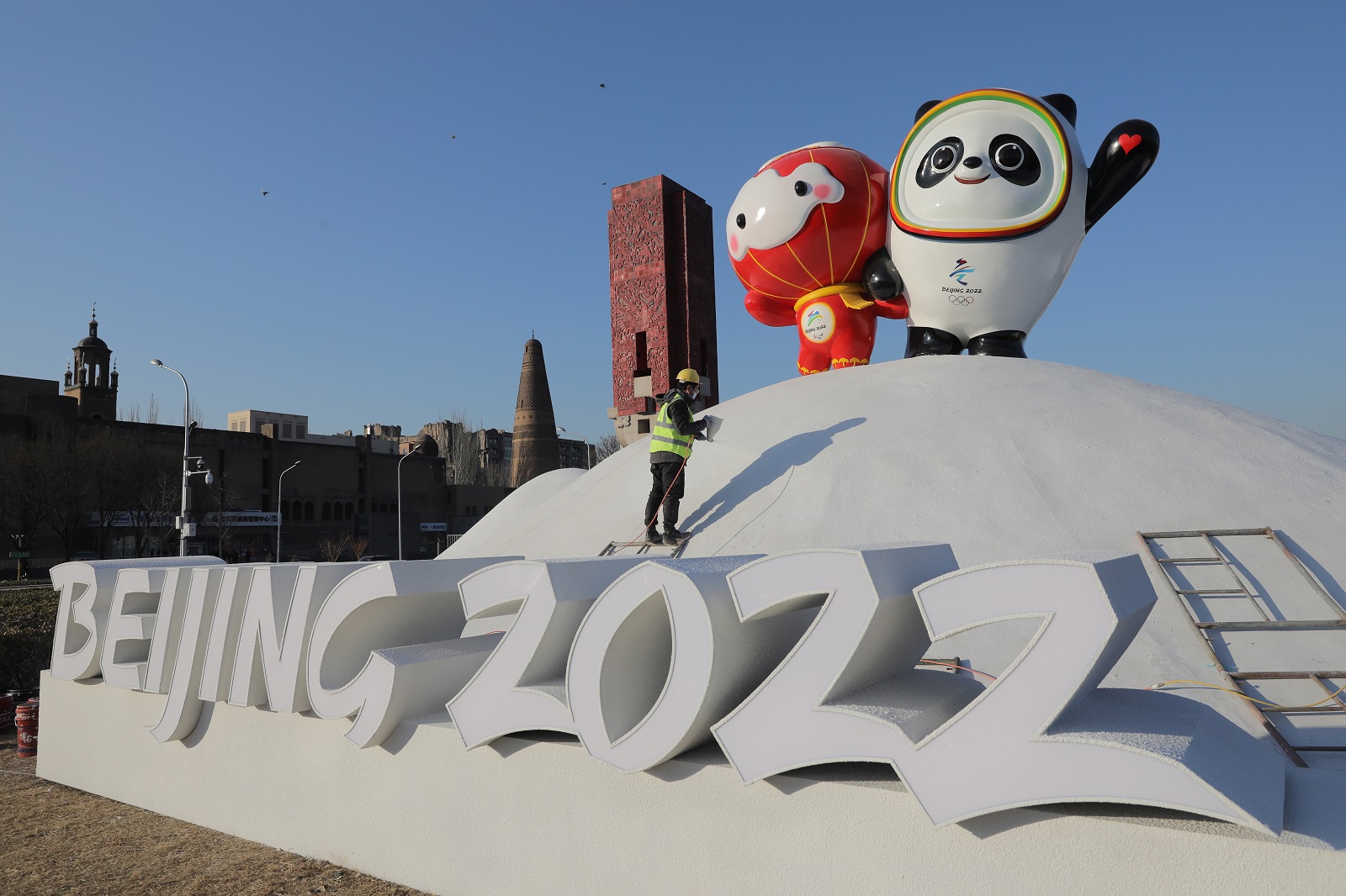 epa09678219 A Chinese worker sprays paint near the Bing Dwen Dwen, the Beijing 2022 Winter Olympic Mascot and Shuey Rhon Rhon, the 2022 Beijing Winter Paralympic Games Mascot, in Beijing, China, 11 January 2022. China is scheduled to host the Beijing 2022 Olympic and Paralympic Winter Games in February, making its capital the first city in the world to host both Summer (2008) and Winter Olympics (2022).  EPA/WU HONG