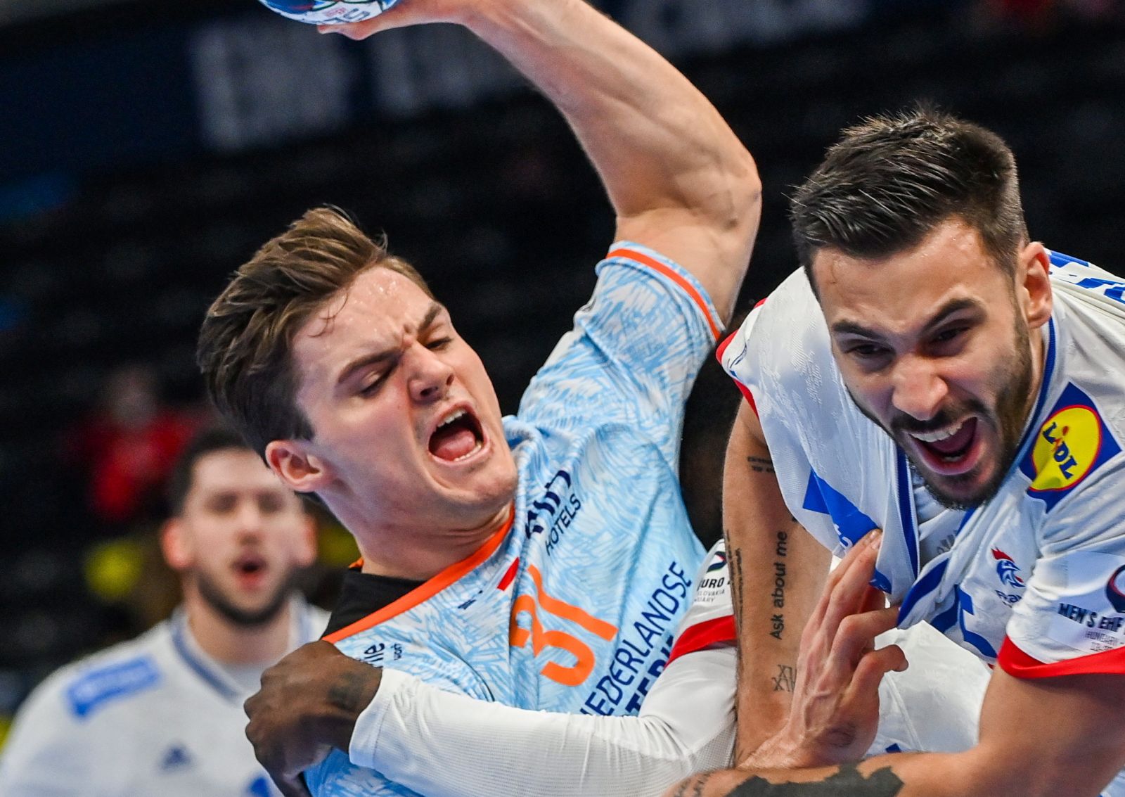 epa09697840 Hugo Descat (R) of France in action against Kay Smits (L) of Netherlands during the Men's European Handball Championship main round  match between France and the Netherlands at the MVM Dome in Budapest, Hungary, 20 January 2022.  EPA/Tibor Illyes HUNGARY OUT