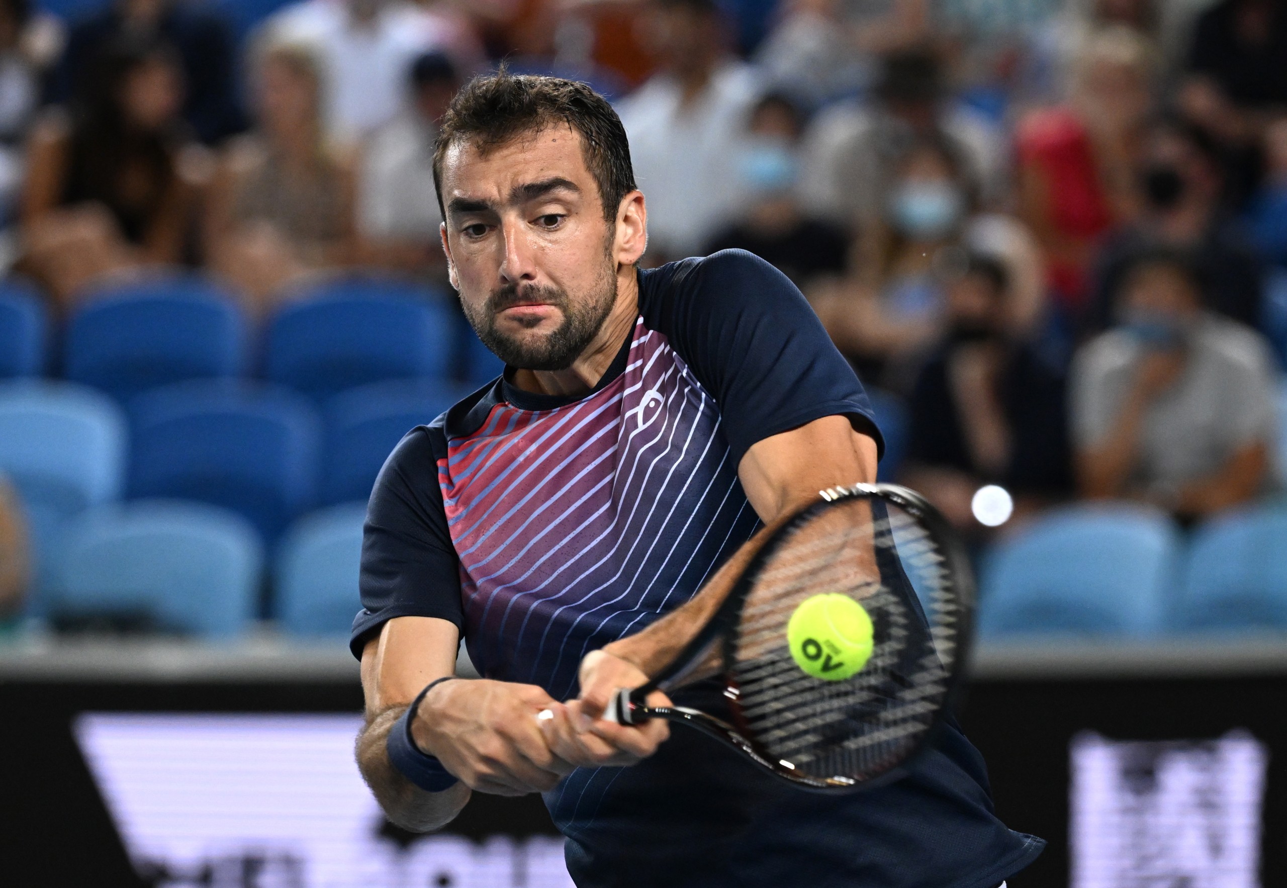 epa09701725 Marin Cilic of Croatia plays a shot during his third round match against Andrey Rublev of Russia on Day 6 of the Australian Open, at Melbourne Park, in Melbourne, Australia, 22 January 2022.  EPA/DEAN LEWINS  AUSTRALIA AND NEW ZEALAND OUT