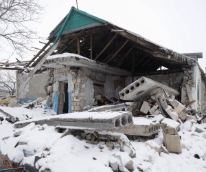 epa09714412 Damage in a shelled building is seen in the Nevelske village about 3 km from the front line, Donetsk area, Ukraine, 28 January 2022. Currently, only five people live here. The last time Nevelske was shelled by pro-Russian militants in November 2021 almost all locals left the village.  EPA/STANISLAV KOZLIUK