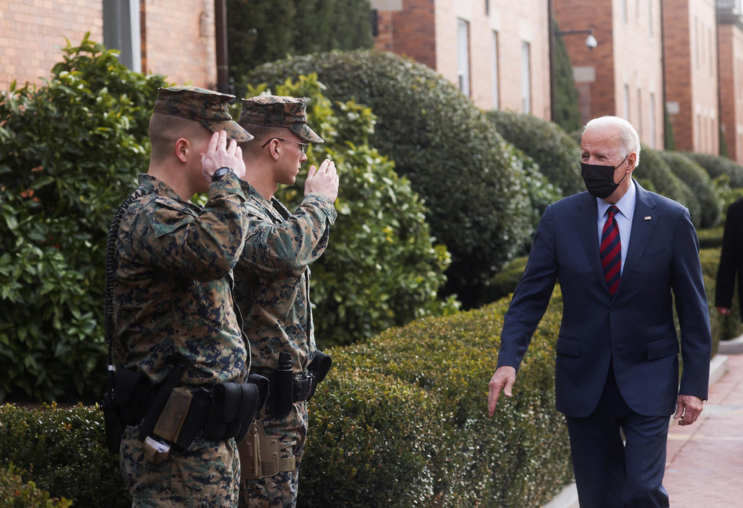 U.S. President Joe Biden is saluted by U.S. Marines on the street in front of their barracks as he visits small businesses along "Barracks Row" on Capitol Hill in Washington, U.S., January 25, 2022. REUTERS/Leah Millis Photo: LEAH MILLIS/REUTERS