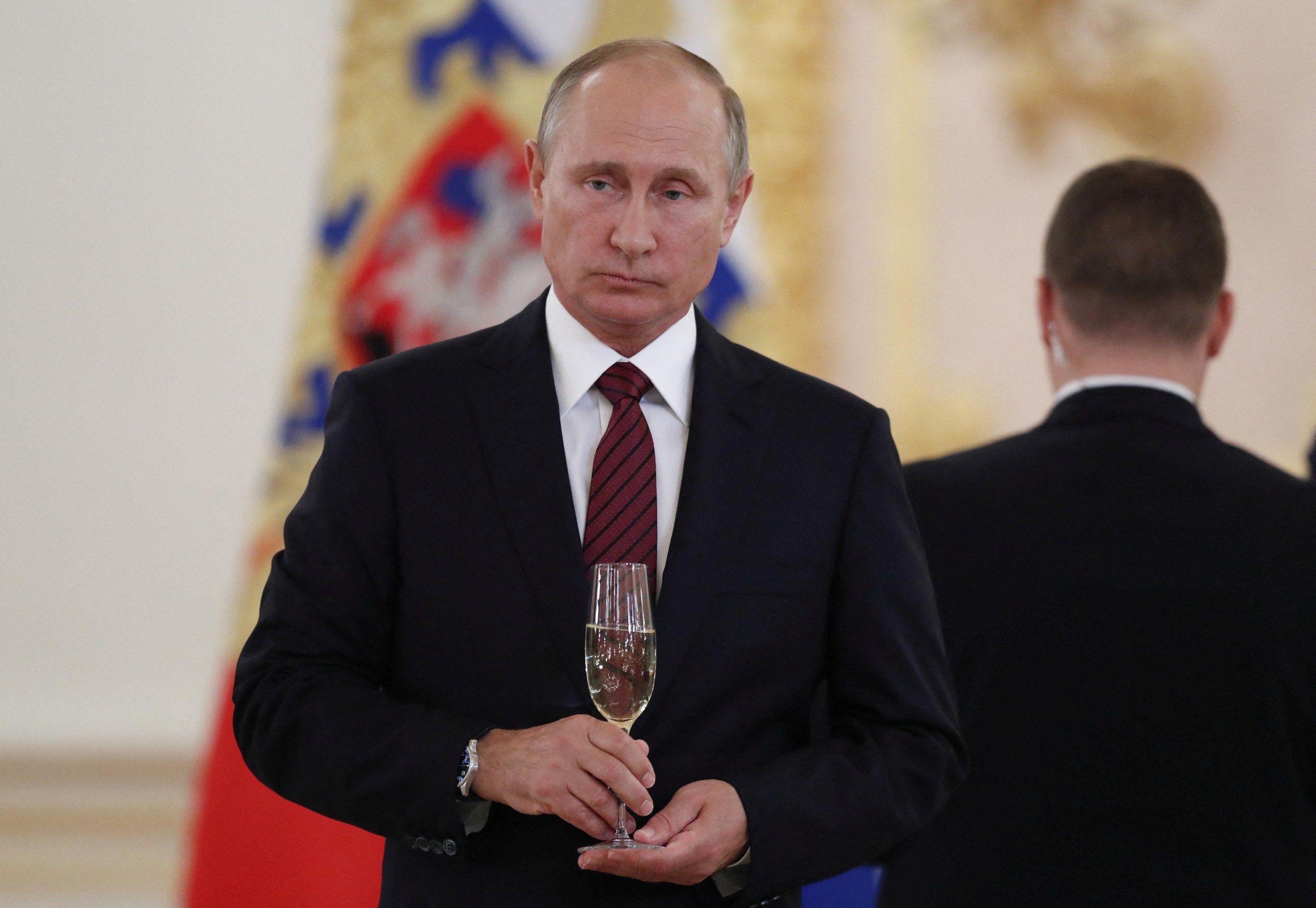 FILE PHOTO: Russian President Vladimir Putin holds a glass of champagne during a ceremony to receive credentials from foreign ambassadors at the Kremlin in Moscow, Russia October 3, 2017. REUTERS/Pavel Golovkin/Pool/File Photo Photo: POOL/REUTERS