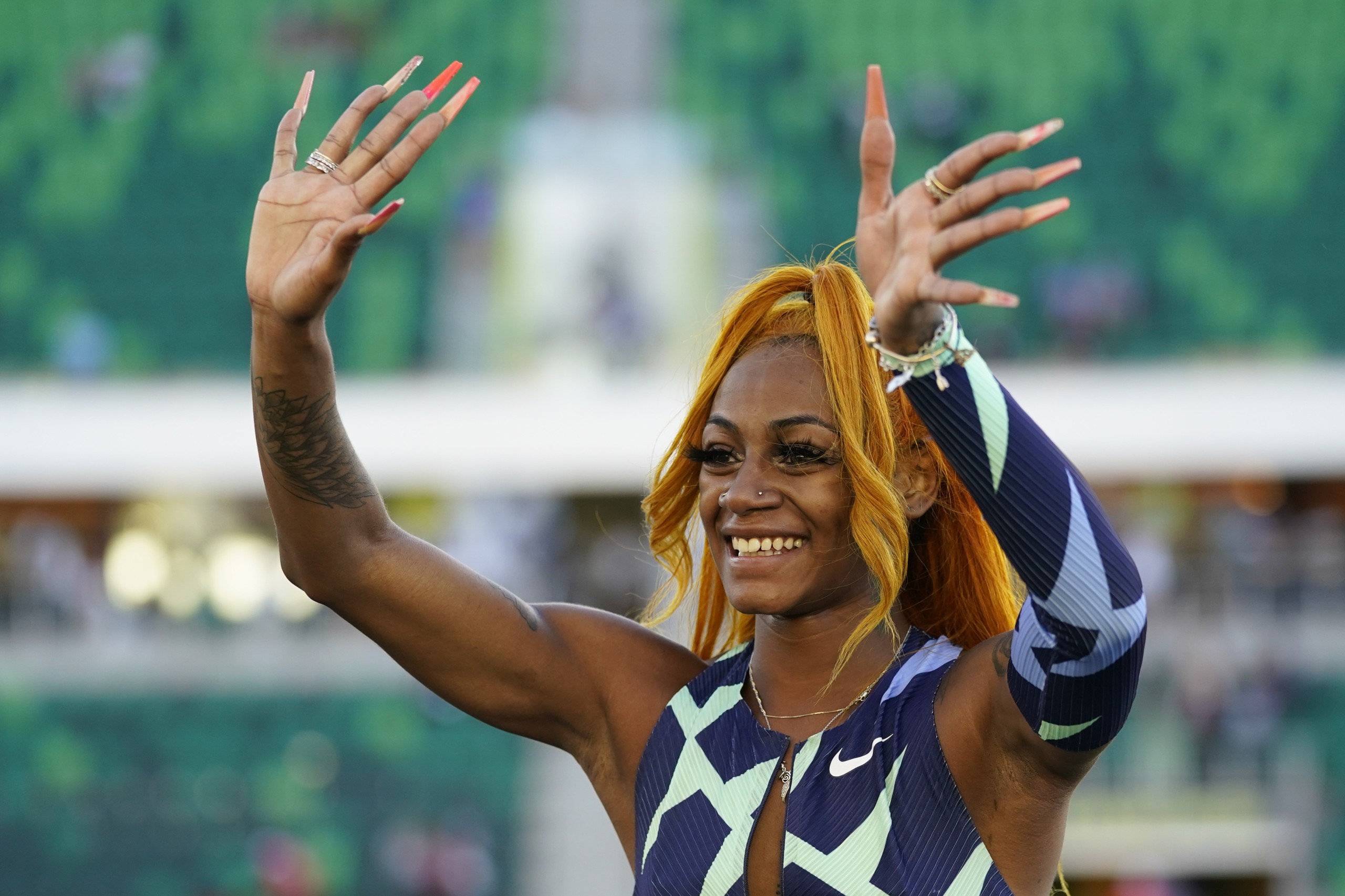 Sha'Carri Richardson waves after winning the women's 100-meter run at the U.S. Olympic Track and Field Trials Saturday, June 19, 2021, in Eugene, Ore. (AP Photo/Ashley Landis)