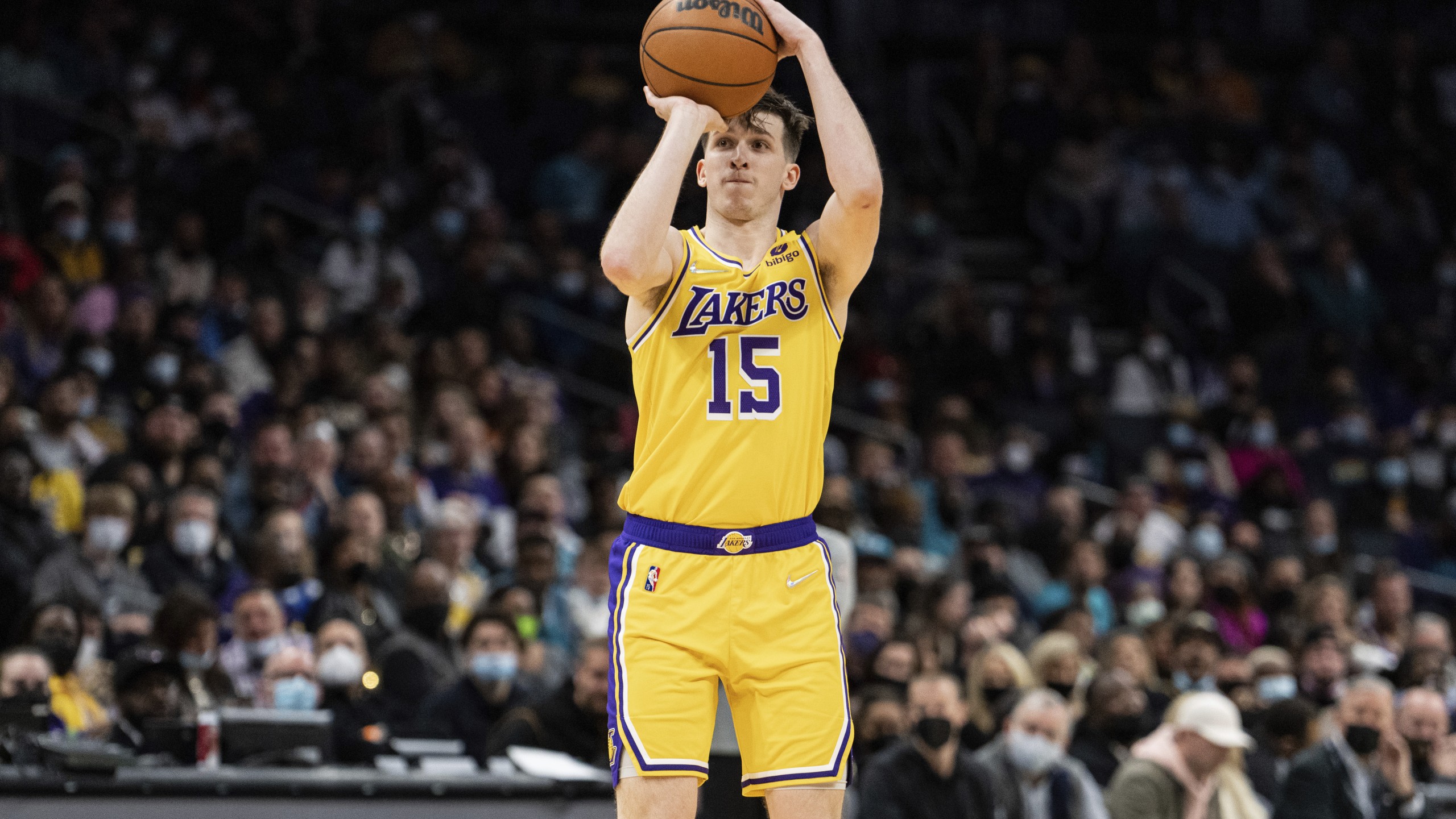 Los Angeles Lakers guard Austin Reaves (15) shoots the ball against the Charlotte Hornets during the second half of an NBA basketball game in Charlotte, N.C., Friday, Jan. 28, 2022. (AP Photo/Jacob Kupferman)