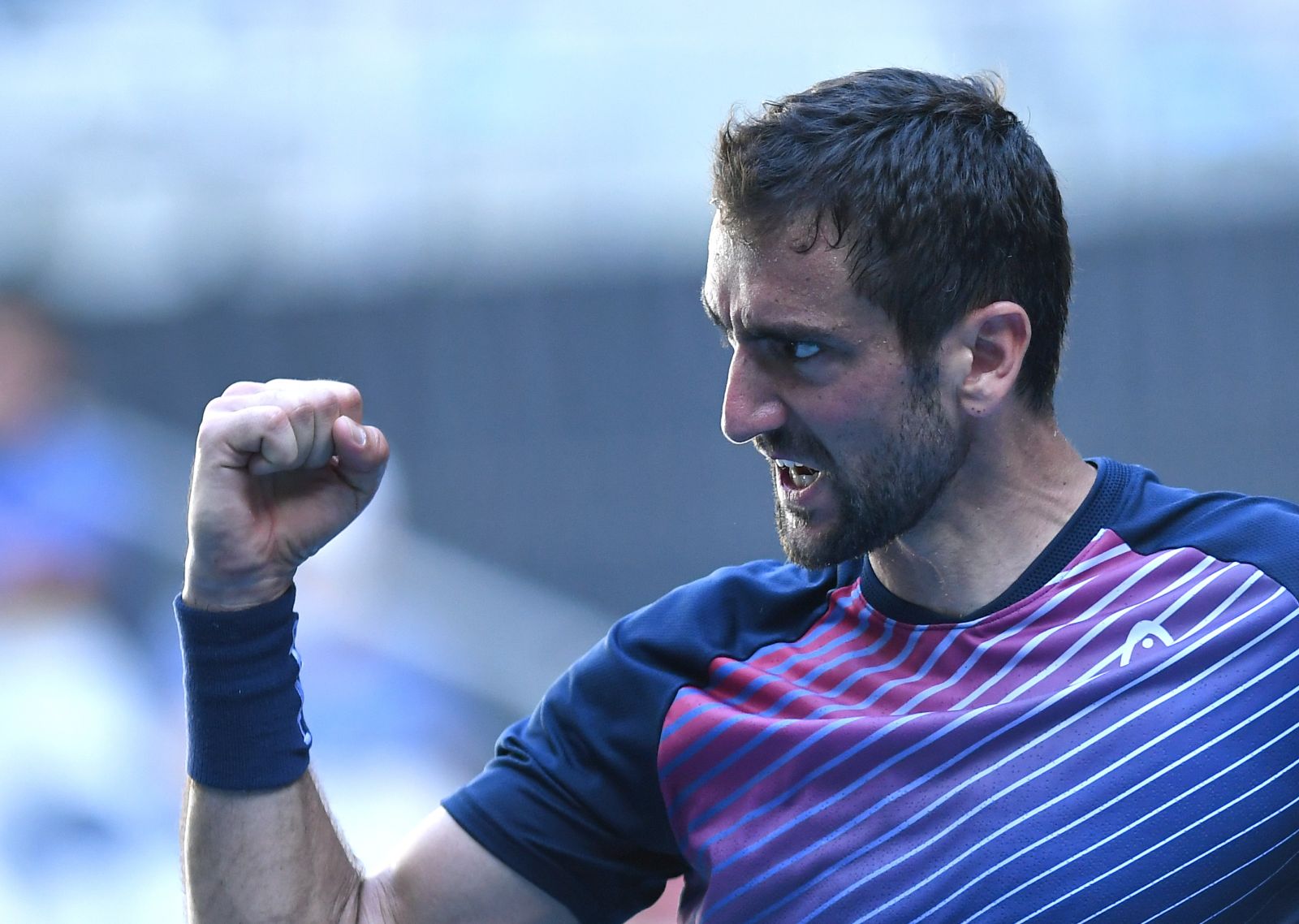 epa09705804 Marin Cilic of Croatia reacts during his fourth round singles match against Felix Auger-Aliassime of Canada at the Australian Open Grand Slam tennis tournament at Melbourne Park, in Melbourne, Australia, 24 January 2022.  EPA/JAMES ROSS  AUSTRALIA AND NEW ZEALAND OUT
