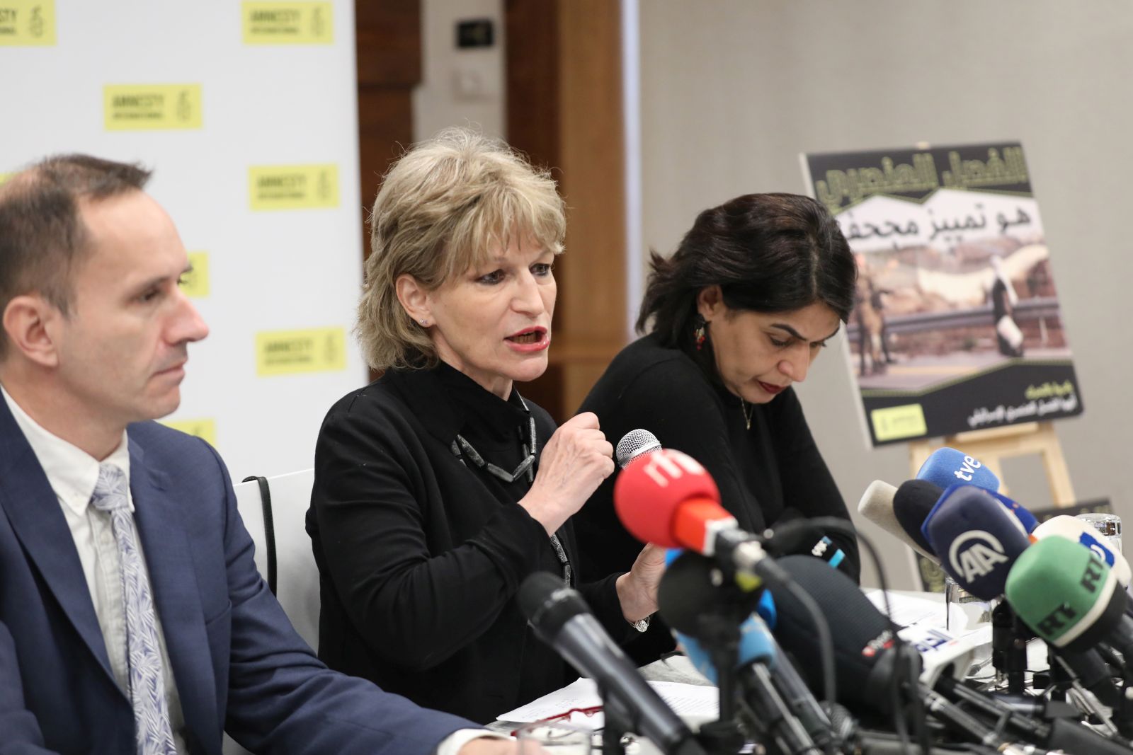 epa09720884 Secretary General of Amnesty International (AI), French human rights expert Agnes Callamard (C) speaks during a press conference in East Jerusalem, 01 February 2022. Amnesty International presented on the day a new report in which they allege that 'Israeli authorities must be held accountable for committing the crime of apartheid against Palestinians'.  EPA/ABIR SULTAN