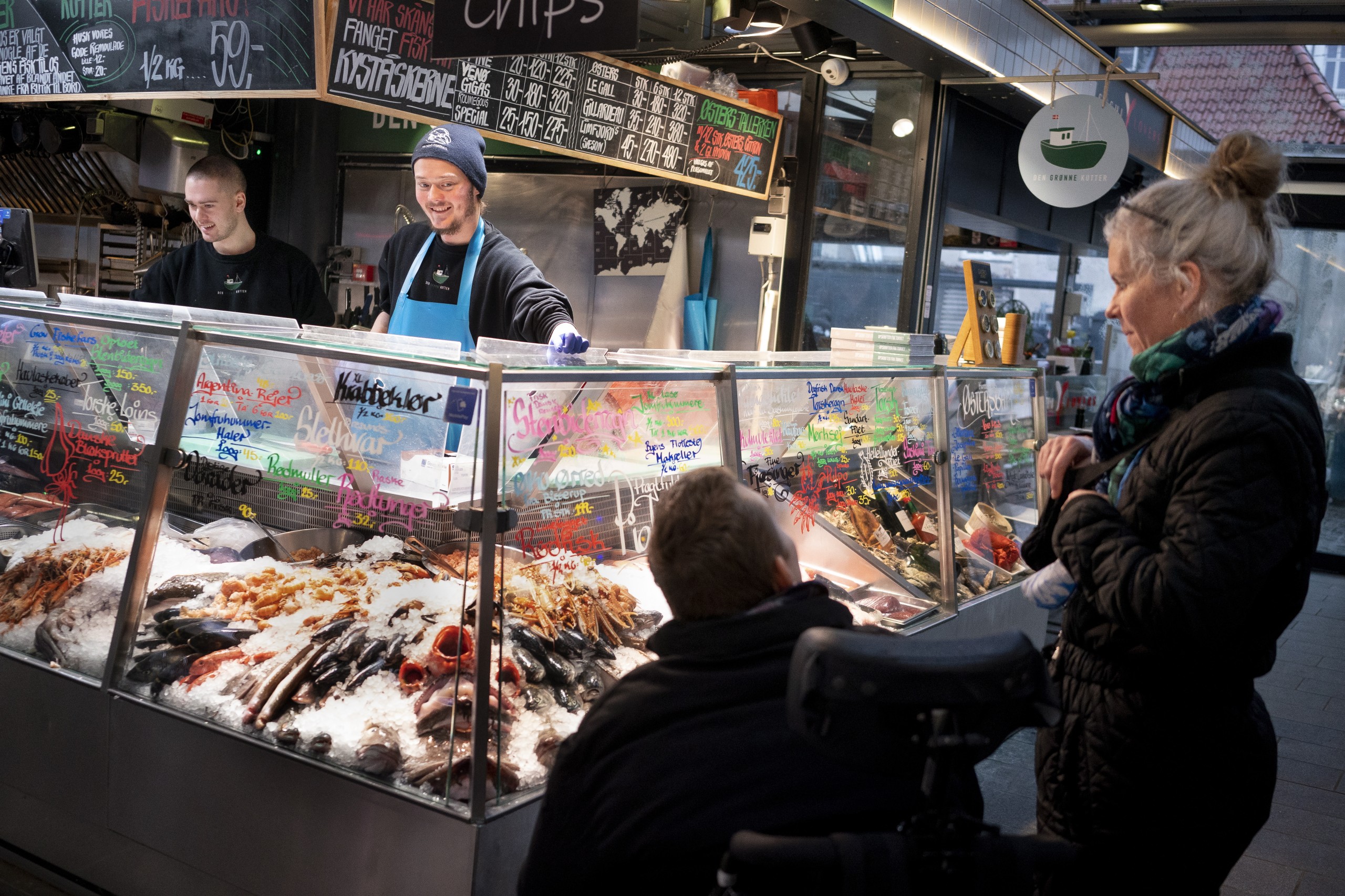 epa09721139 Customers at the fishmarket in Torvehallerne in Copenhagen, Denmark, 01 February 2022. As of today it is no longer mandatory to wear protection mask anywhere in public in Denmark. The Danish Government decided that COVID-19 is no longer categorized as a socially critical disease after 31 January 2022, and lifted its COVID restrictions.  EPA/LISELOTTE SABROE  DENMARK OUT